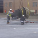 Two HighLine Rigging Employees Moving Large Construction Piece with Crane